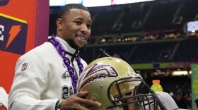 Saquon Barkley with Whitehall helmet at Super Bowl media night