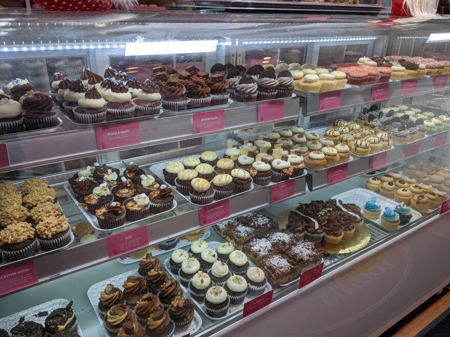Sweet Girlz Bakery cupcakes display case holds red velvet, black and white cupcakes and original crumb cake.jpg