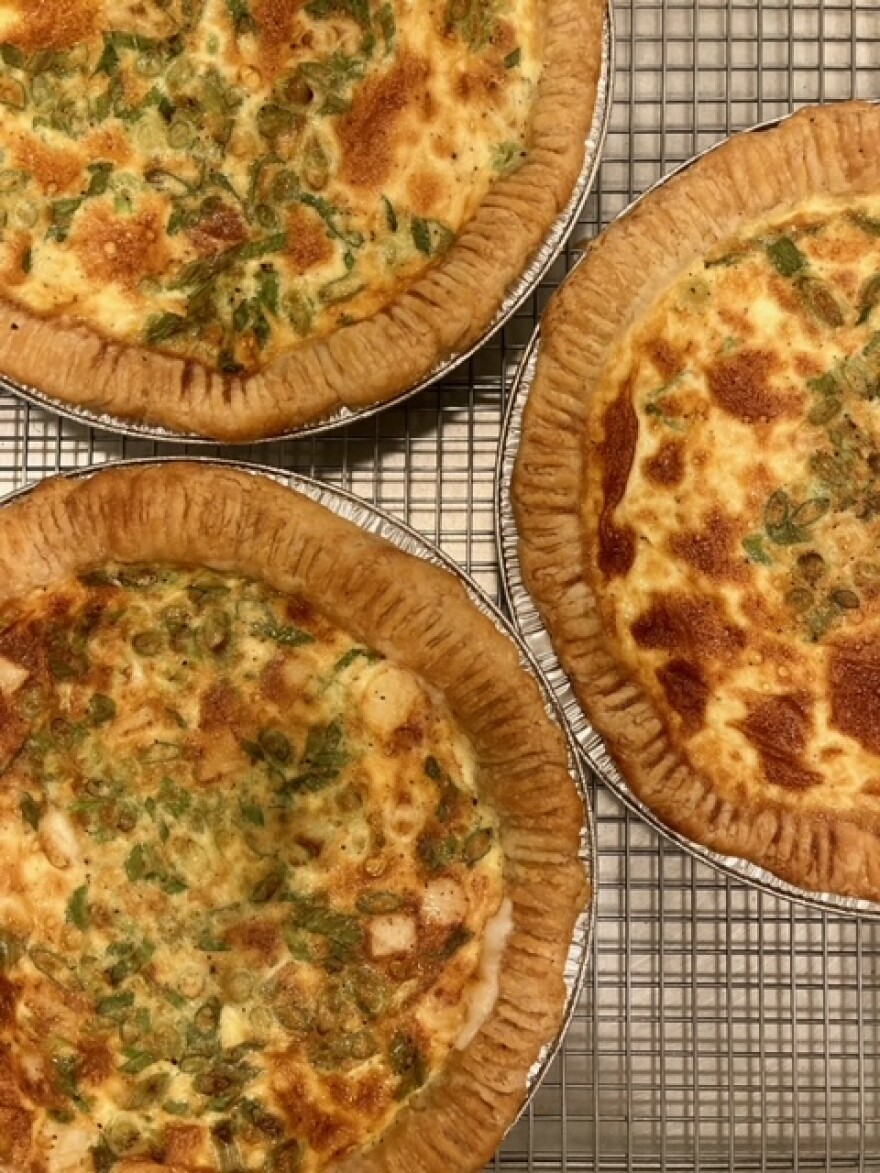 Three savory pies sit on a metal cooling rack.jpeg