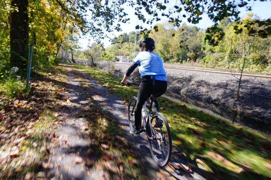 A person rides a bike on a trail