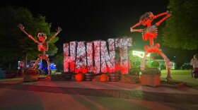 sign that reads haunt with giant skeletons on either side