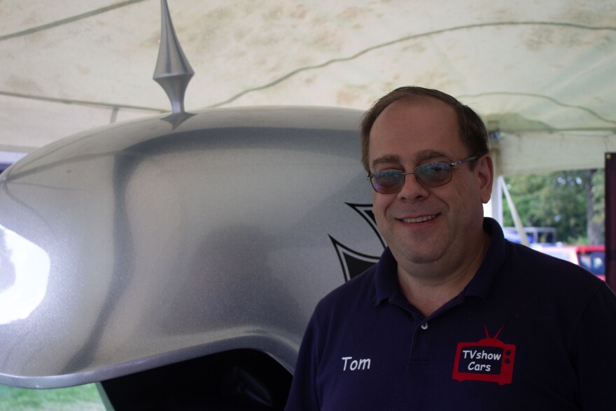 Tom Jeron poses in front of the Red Barron custom car
