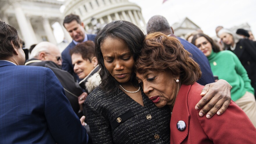 Dr. Serena Liebengood, center, the wife of the late U.S. Capitol Police Officer Howard Liebengood, and Rep. Maxine Waters, D-Calif., embrace during a ceremony to mark the second anniversary of the Jan. 6 riot at the U.S. Capitol on Friday. Officer Liebengood received the Presidential Citizens Medal posthumously.