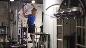 A woman replaces an air filter in Greeley, Colo., in 2020. Chemical health experts recommend homeowners check air filters and indoor air quality to prepare for any chemical hazards in the future.