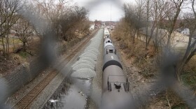 A Norfolk Southern train runs through East Palestine less than two weeks after a derailment on Feb. 3.