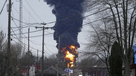 A black plume rises over East Palestine, Ohio, as a result of a controlled detonation of a portion of the derailed Norfolk Southern Monday, Feb. 6, 2023.