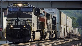 FILE - A Norfolk Southern freight train runs through a crossing on Sept. 14, 2022, in Homestead, Pa. Norfolk Southern hauled in 27% more third-quarter profit, Wednesday, Oct. 26,  as the railroad increased shipping rates and reduced the number of delayed deliveries that shippers have been complaining about this year. The Atlanta-based railroad said it earned $958 million, or $4.10 per share, in the quarter.
