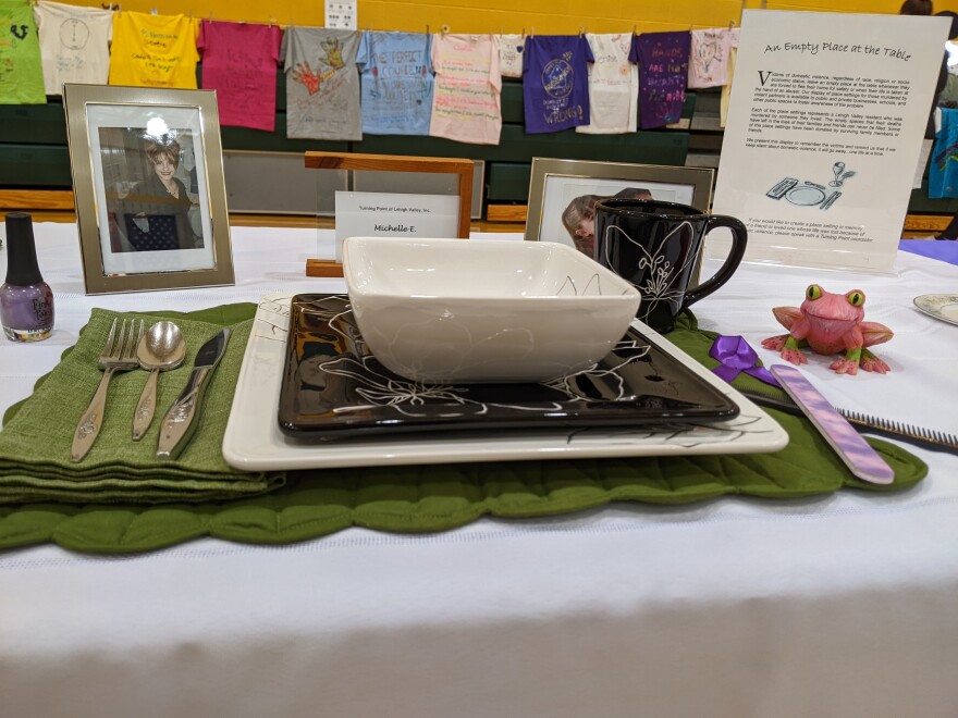 Vigil - Place setting for Michelle T with t-shirts in background.jpg