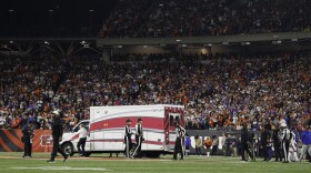 Fans look on as the ambulance leaves carrying Buffalo Bills player Damar Hamlin off the field on Jan. 2 after he collapsed after making a tackle against the Cincinnati Bengals.