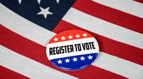 register to vote text on election button with American flag