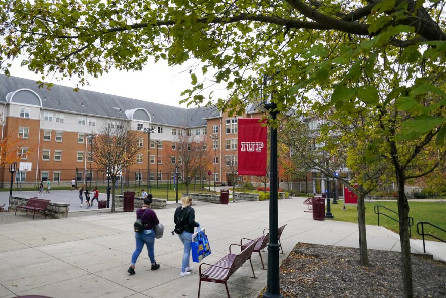 Students walk on the campus of Indiana University of Pennsylvania in Indiana, Pa, on Wednesday, Oct. 21, 2020.