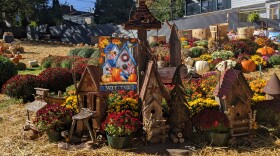 Pumpkins, mums and fall decorations sit on beds of hay at the Centennial Park in West Ward.jpg