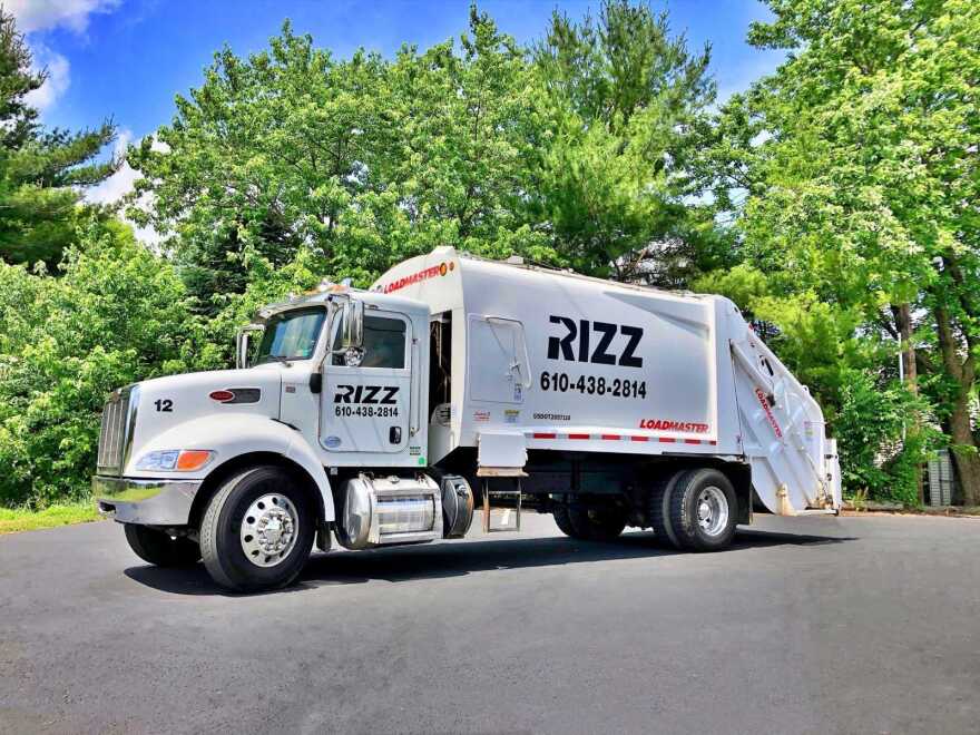 A white RIZZ Containers & Disposal