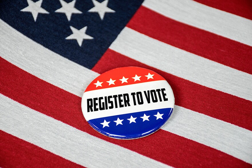 register to vote text on election button with American flag