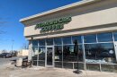 The exterior of a strip mall Starbucks from the outside