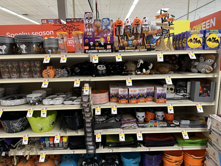 Picture of an assorted section of Halloween candy and decor at a grocery store.