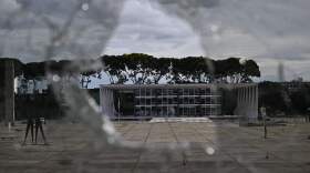 Brazil's Supreme Court building is seen through a broken window of the Planalto presidential building in Brasília on Monday, a day after supporters of Brazil's far-right ex-president, Jair Bolsonaro, invaded the Congress, presidential palace and Supreme Court.