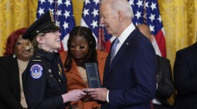 President Biden awards the Presidential Citizens Medal, the nation's second-highest civilian honor, to U.S. Capitol Police officer Caroline Edwards during a ceremony to mark the second anniversary of the Jan. 6 assault on the Capitol in the East Room of the White House on Friday.