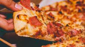 close-up-photo-of-person-holding-pizza