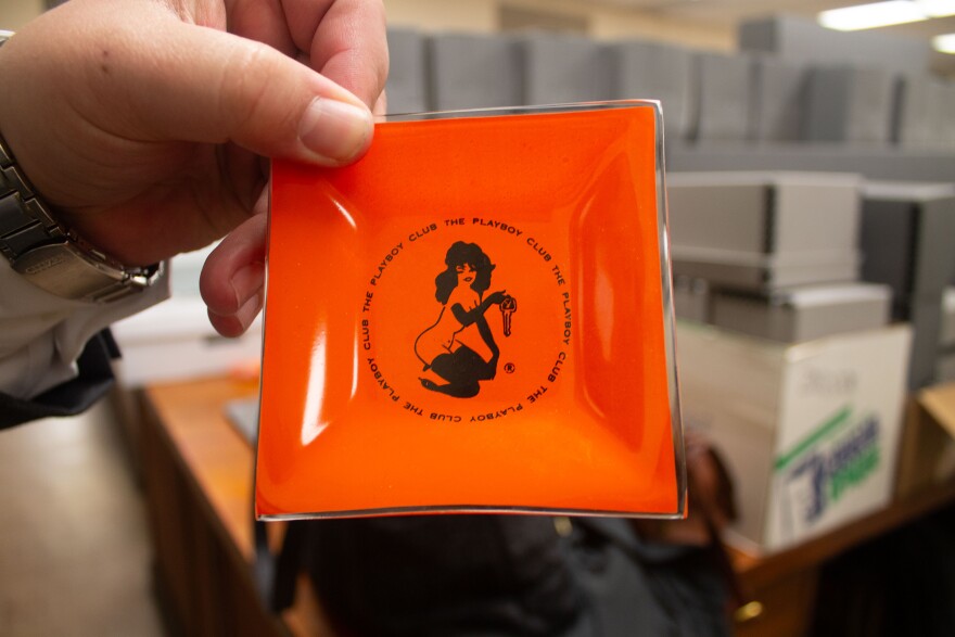 Nicholas Zmijewski holds a Playboy Club ashtray.