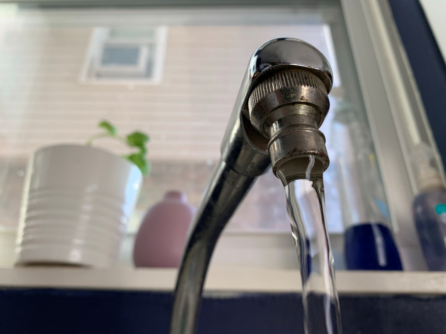 Water flowing through a faucet.