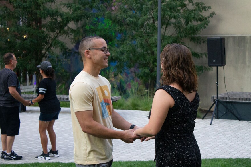 A couple holds hands while learning Bachata dancing in Allentown