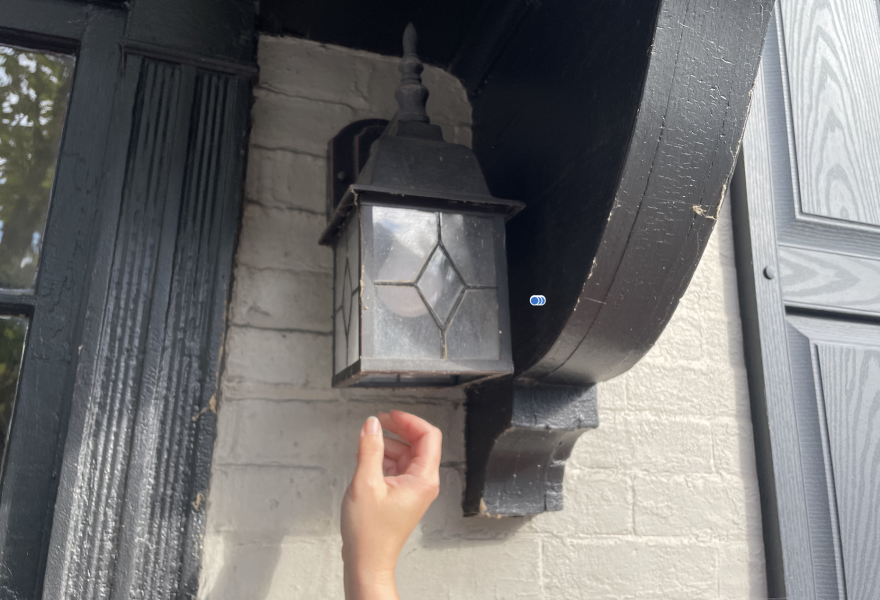 Volunteer April Tou installs a dusk-to-dawn light in Bethlehem.
