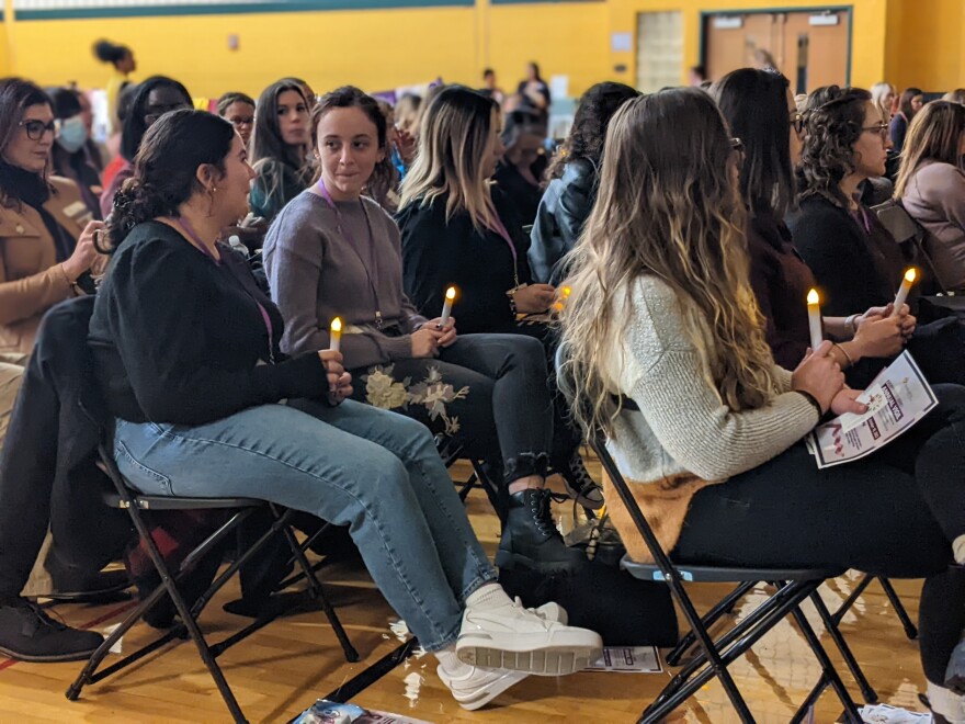 Vigil - Crowd holding candles for victims of domestic and intimate partner violence.jpg