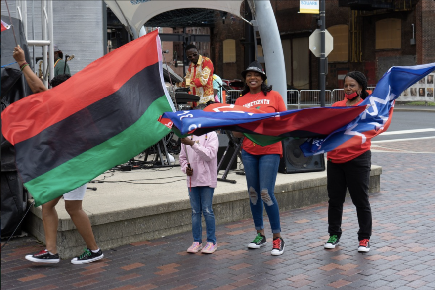 Flag waiving in honor of Juneteenth.