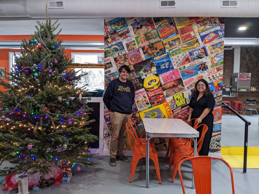 Punch Out Games - Mik and Babs by donated board game wall.jpg