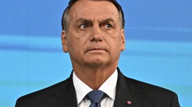 Former Brazilian President Jair Bolsonaro, pictured here at an election debate in October, left his country for Florida two days before his term ended.