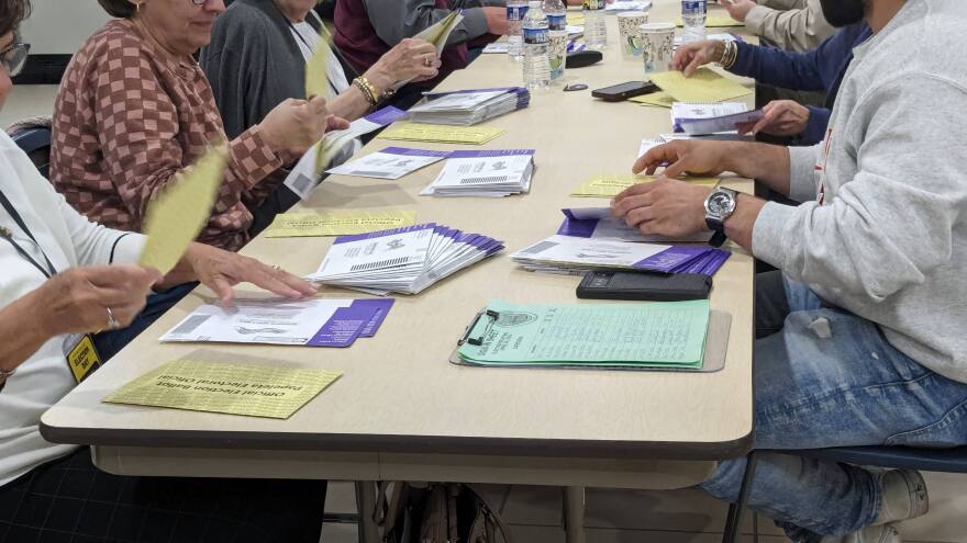 Northampton County volunteers remove mail-in ballots from their envelopes.