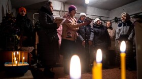 Worshipers pray during an Orthodox Christmas mass in a basement shelter in Chasiv Yar, eastern Ukraine, on Jan. 7. As artillery boomed outside and fighter jets flew overhead, Orthodox Christians in a battered eastern Ukraine town held a Christmas service in a basement shelter vowing, not to let war ruin the holiday.