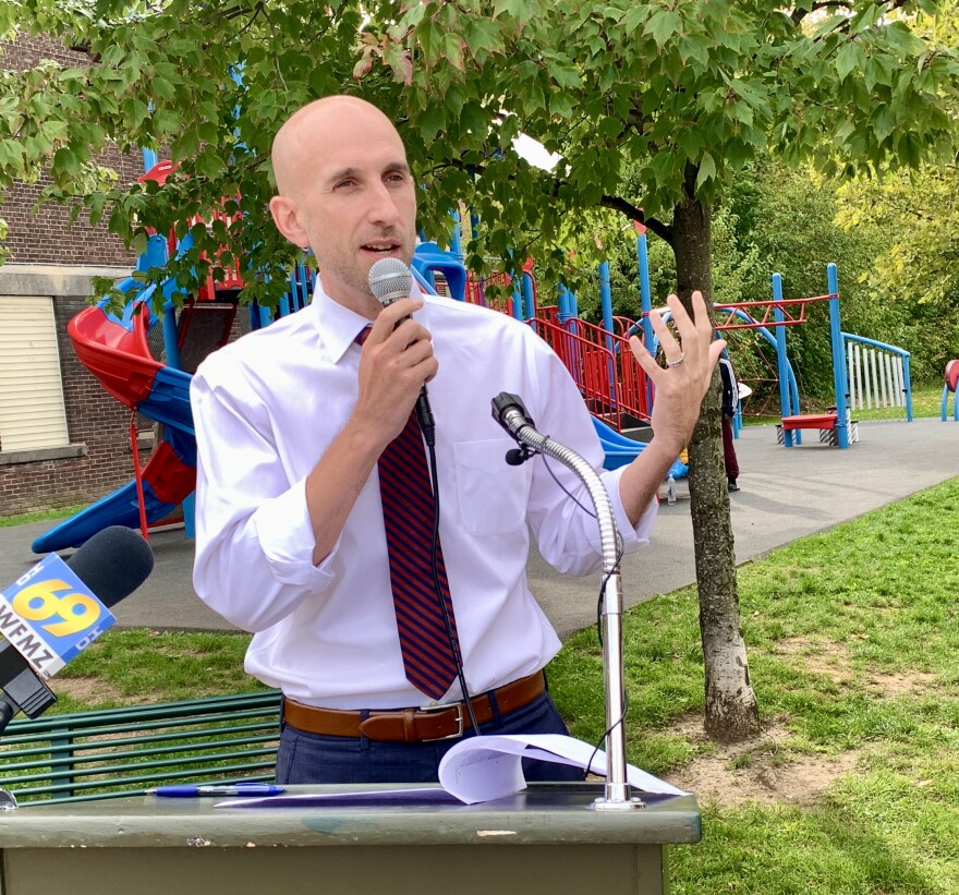 Bethlehem Mayor J. William Reynolds speaks at a riser in front of the playground at Southside Greenway.