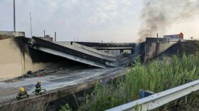 Firefighters work near a section of I-95 in Philadelphia that collapsed Sunday following a vehicle fire.