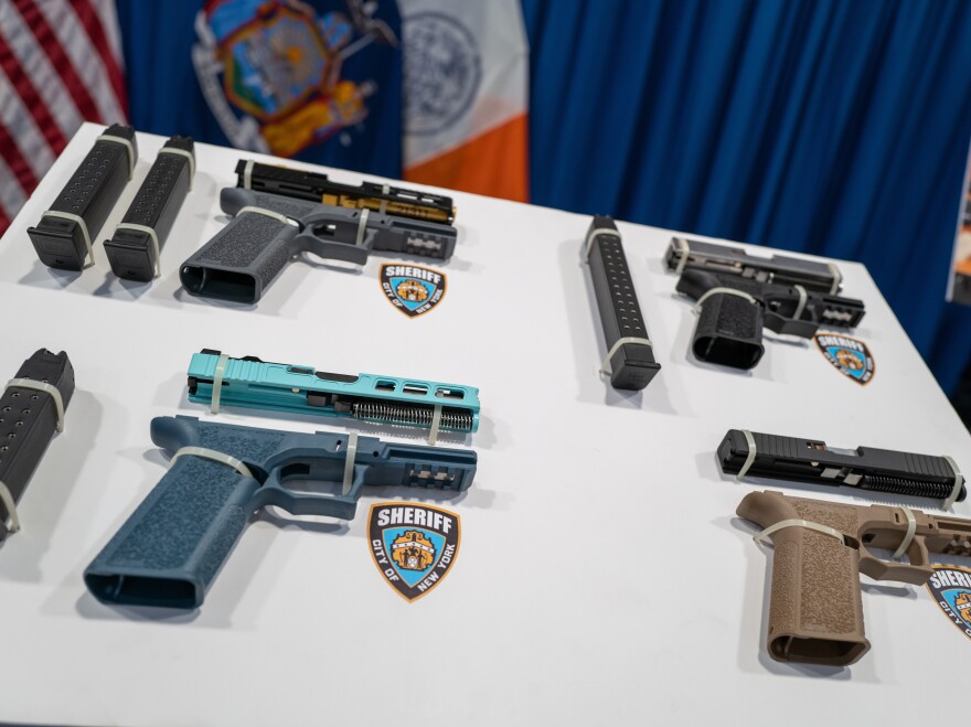 Confiscated "ghost guns" are displayed before a news conference with New York Mayor Eric Adams and Attorney General Letitia James and others.