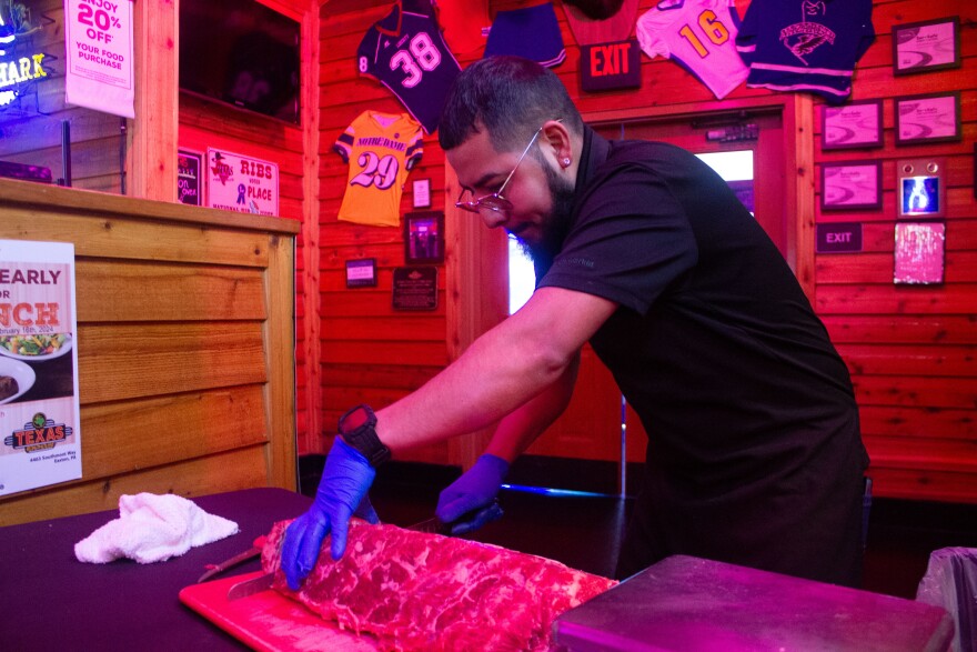 Miguel Barragan cutting meat