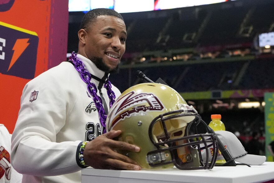 Saquon Barkley with Whitehall helmet at Super Bowl media night