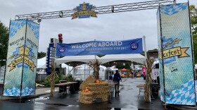 The entrance to Oktoberfest , with a haystack, pumpkins and dried corn.